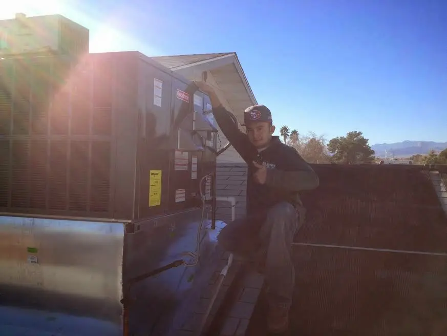 HVAC technician performing HVAC Inspection on a rooftop unit in Centerville